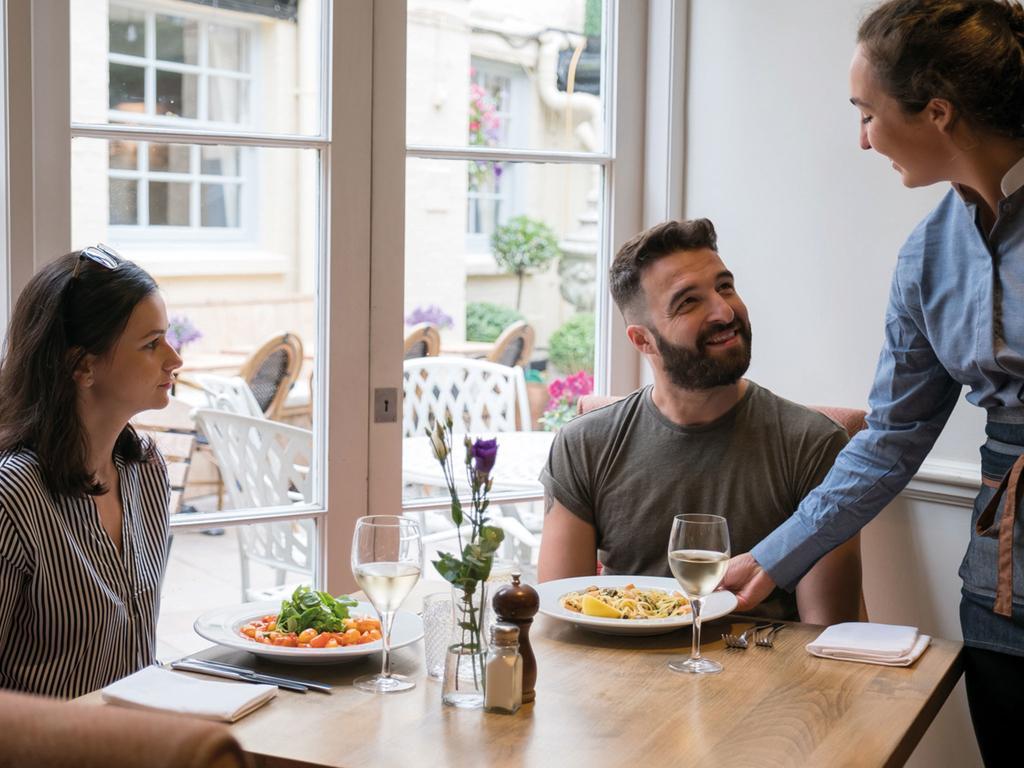 The Fleece At Cirencester Exterior foto A waitress serving customers